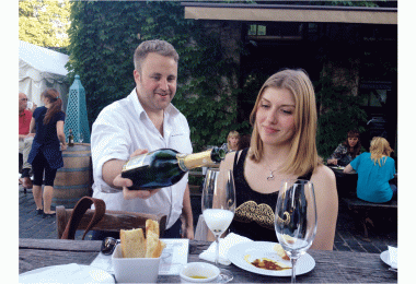 Mielżyński manager Tomasz Zaremba pours Champagne for Ela Chwiałkowska