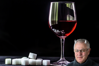 Glass of wine with sugar cubes and Robert Joseph with horns. (Image: Cath Lowe and Midjourney AI)